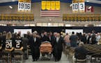Pallbearers carried the casket of Henry Boucha out of the Gardens Arena as his high school uniform number, 16, hung from the rafters following his fun