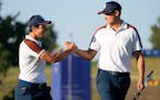 Europe’s Ludvig Aberg, right, and playing partner Europe’s Viktor Hovland celebrate on the 3rd free during their morning Foursomes match at the Ry