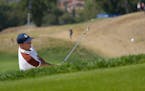 Europe’s Rory Mcilroy plays out of a bunker on the 6th hole during his afternoon Fourballs match at the Ryder Cup golf tournament at the Marco Simon