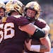 Gophers quarterback Athan Kaliakmanis (8) celebrated with offensive lineman Nathan Boe (66) after Kaliakmanis scored a second-quarter touchdown agains