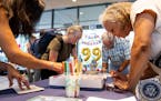 People wroe birthday cards for former President Jimmy Carter during a celebration for his 99th birthday held at the Carter Center in Atlanta on Saturd