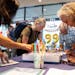 People wroe birthday cards for former President Jimmy Carter during a celebration for his 99th birthday held at the Carter Center in Atlanta on Saturd