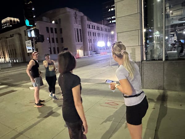 Elaine Jones, left foreground, and Katie Virnig learned of the races’ cancellation Sunday morning, in downtown Minneapolis.