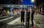 Workers break down the scene for the start of the Twin Cities Marathon and TC 10 Mile on Sunday morning in downtown Minneapolis.