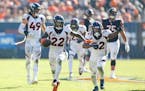 Kareem Jackson (22) celebrated with fellow Broncos safety Delarrin Turner-Yell (32) after his winning interception of a pass by Bears quarterback Just