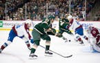 Wild center Marco Rossi (23) got a shot off in the first period while defended by Colorado Avalanche center Joel Kiviranta (94) on Thursday night at X