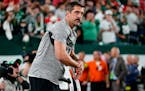 Jets quarterback Aaron Rodgers stood on the field before Sunday night’s game against the Chiefs.