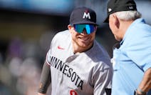 Twins catcher Christian Vázquez, sharing a laugh with umpire Larry Vanover, started at first base Sunday and finished at second, as the Twins kept it