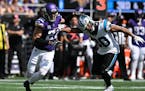 Harrison Smith (22) of the Minnesota Vikings pass rushes against Chuba Hubbard (30) in the second quarter.