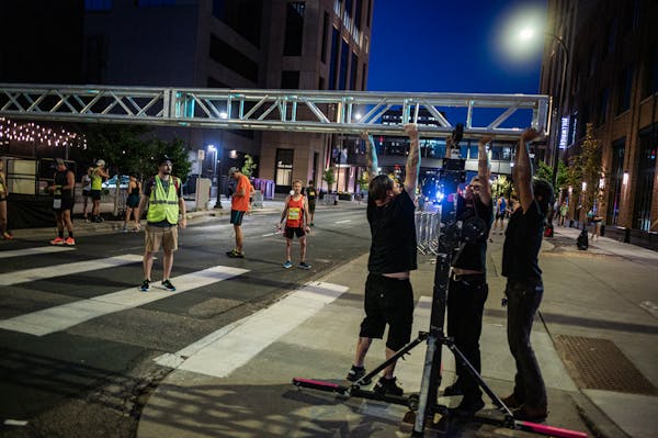 Officials start to take down infrastructure for the 10-mile race in Minneapolis, Minnesota, on Sunday, Oct. 1, 2023. The Twin Cities Marathon and 10 m