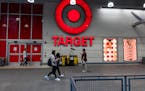 People walk by a Target in Harlem on Sept. 28 in New York City. The retailer said it will close its East Harlem location and eight others in Seattle, 