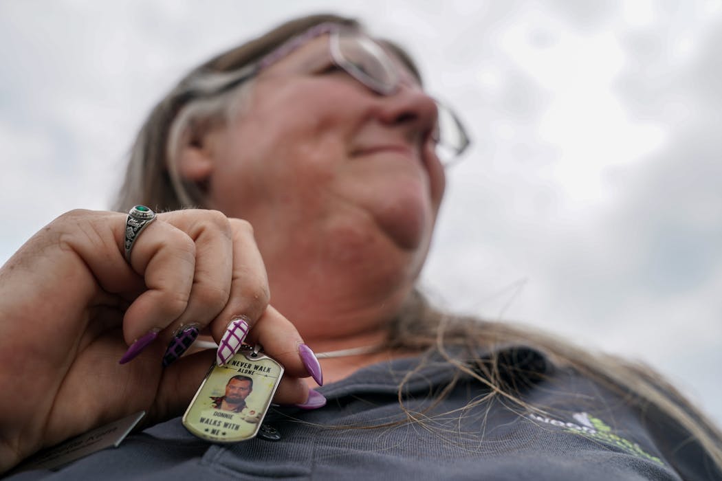 Janette Kern of Clarksville, Ind., wears a pendant with a photograph of her son Donnie DeJarnette, who died two years ago at age 25. 