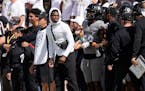 Injured Colorado defensive back Travis Hunter, center, looked on from the sideline in the second half against Southern California on Saturday in Bould