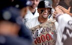 Royce Lewis celebrated in the dugout after his second home run — scoring all three of the game’s runs — on Tuesday at Target Field.