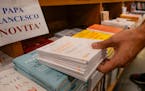 Copies of Pope Francis’ latest encyclical letter on environment “Laudate Deum” are prepared for sale in a bookshop in Rome, Wednesday, Oct. 4, 2