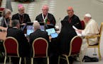 Pope Francis, right, speaks during the opening session of the 16th General Assembly of the Synod of Bishops in the Paul VI Hall at the Vatican on Wedn