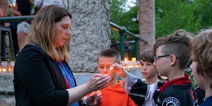 Hilary Brasel lighted children’s candles during a May vigil for her husband, Michael Brasel, at Langford Park in St. Paul, Minn. Michael was shot an
