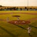 With the sun low in the sky, the Miesville Mudhens took infield practice before a game at Jack Ruhr Field in 2005.