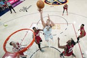 Nikola Jokic (15) and the Denver Nuggets won the NBA title in June by beating Jimmy Butler (22) and the Miami Heat.