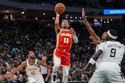 Hawks star Trae Young jumped to shoot a basket during the first half Sunday night in Milwaukee, a game Atlanta won 127-110.