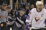 Adam Johnson c(center) celebrated a goal that he scored for Hibbing during the 2011 Minnesota state hockey tournament.