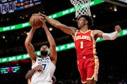 Jalen Johnson of the Hawks soared to block a shot by Timberwolves center Rudy Gobert in the second half Monday in Atlanta.