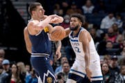 Karl Anthony Towns steals the ball from Nikola Jokic in the first quarter.