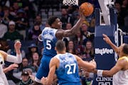 Timberwolves guard Anthony Edwards passed the ball under the net during the first half against the Jazz at Target Center