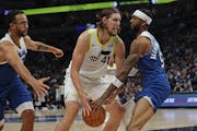 The Wolves’ Nickeil Alexander-Walker (right) and Kyle Anderson double-teamed Utah forward Kelly Olynyk on Saturday. The Wolves have the top-rated de