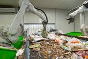 Robotic arms used artificial intelligence to sort green food scrap bags from incoming waste Thursday at the Ramsey/Washington Recycling & Energy Cente