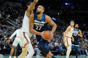 The Timberwolves’ Rudy Gobert (27) drove against the Spurs’ Victor Wembanyama during the first half Friday in San Antonio. 
