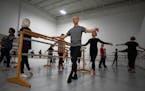 Matthew LaVoie holds on to the barre during a Boomer Ballet class inside the St. Paul Ballet studio Nov. 7. 