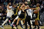 Warriors guard Klay Thompson, front, and forward Draymond Green, left, got into an altercation with Wolves center Rudy Gobert, back, and forward Jaden