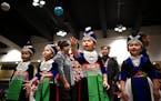 From left, twin sisters Hazel and Hannah Xiong and their cousins Madison Lee and Sophia Moua played the classic Hmong game Pov Pob at the 2022 Hmong N