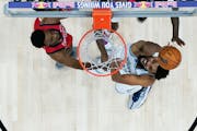 Timberwolves center Karl-Anthony Towns went to the basket against Pelicans forward Herbert Jones, left, in the first half in New Orleans on Saturday.