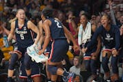 Paige Bueckers (5) celebrated a UConn basket with teammate KK Arnold at the end of the third quarter against the Gophers on Sunday.