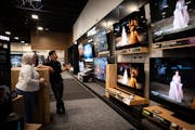Jane Burbank gets help last week from employee Chris Sanchez as she chooses a television at the Richfield Best Buy store. Best Buy CEO Corie Barry sai