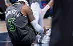 Jaden McDaniels held his right leg after being injured during Monday night’s game at Target Center.