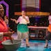 Lynnea Doublette walks by as Camryn Buelow and Olivia Kemp dance in the Hamburger Helper scene of History Theatre’s “I am Betty.”