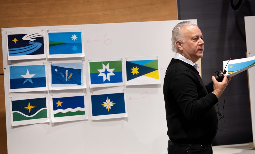 Commission chair Luis Fitch started the discussion of the highest-ranked flag designs, seen behind him at Tuesday’s meeting.