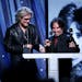 Daryl Hall, left, and John Oates, of Hall & Oates, accept their award during the Rock and Roll Hall of Fame Induction Ceremony at the Barclays Center 