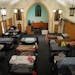 Bunk beds replace pews inside the former Zion Lutheran Church now utilized by Simpson Housing Services as a temporary homeless shelter in Minneapolis.