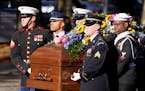 A military team carries the casket of former first lady Rosalynn Carter upon arrival at the Jimmy Carter Presidential Library and Museum, Monday, Nov.