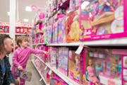 Nevin Kennedy looked at Barbie dolls on Nov. 21 at Target in Edina with his daughter Luna, 4. Son Bart, 6 months, isn’t pictured.