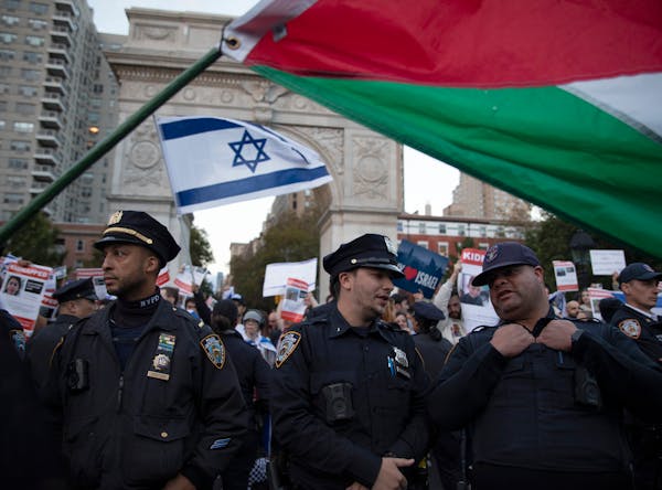 Police officers create a barrier between both Israel and Palestine protesters at Washington Square Park in New York on Tuesday, Oct. 17, 2023.