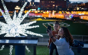 Ana Perez and her daughter Iivy Perez, 6, enjoyed the lights at the GLOW Holiday Festival at CHS Field in St. Paul.