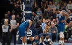 A trainer checked on Minnesota Timberwolves guard Anthony Edwards (5) after a hard landing on the court in the third quarter. The Minnesota Timberwolv