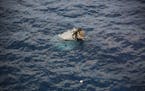 In this photo provided by Japan Coast Guard, debris believed to be from a U.S. military Osprey aircraft is seen off the coast of Yakushima Island in K