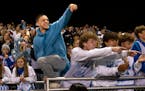 Students and fans cheer for the Bloomington Jefferson Jaguars after their win against the Robbinsdale Cooper Hawks at the Bloomington Jefferson Footba