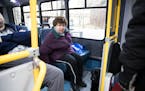 Lolly Lijewski, who uses a seeing eye dog named Jiffy for vision impairment, settled into a Metro Mobility bus after being picked up outside her home 